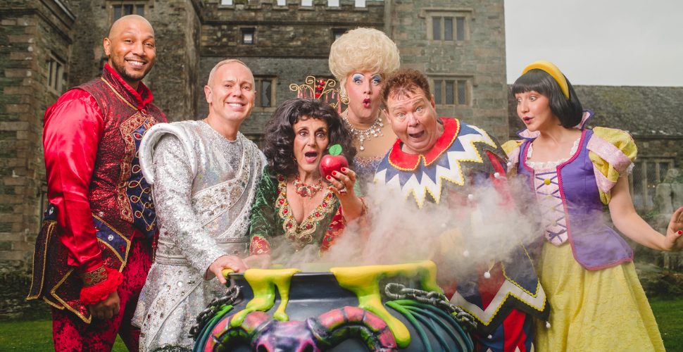 The cast of the pantomime outside a brick building